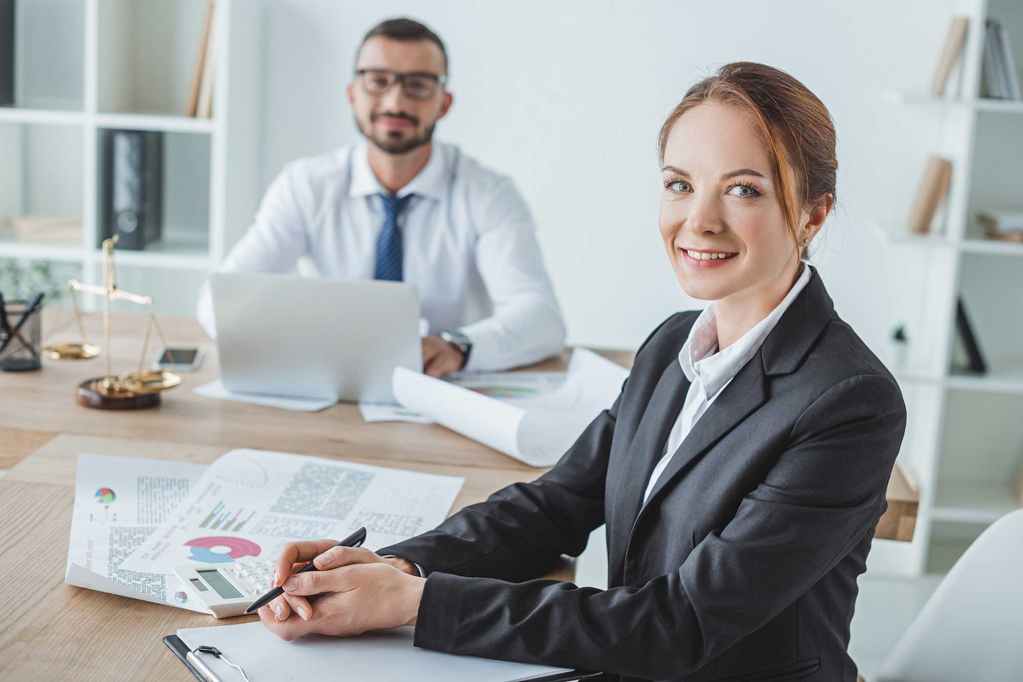 smiling-financiers-looking-at-camera-in-office-2023-11-27-05-34-53-utc.jpg